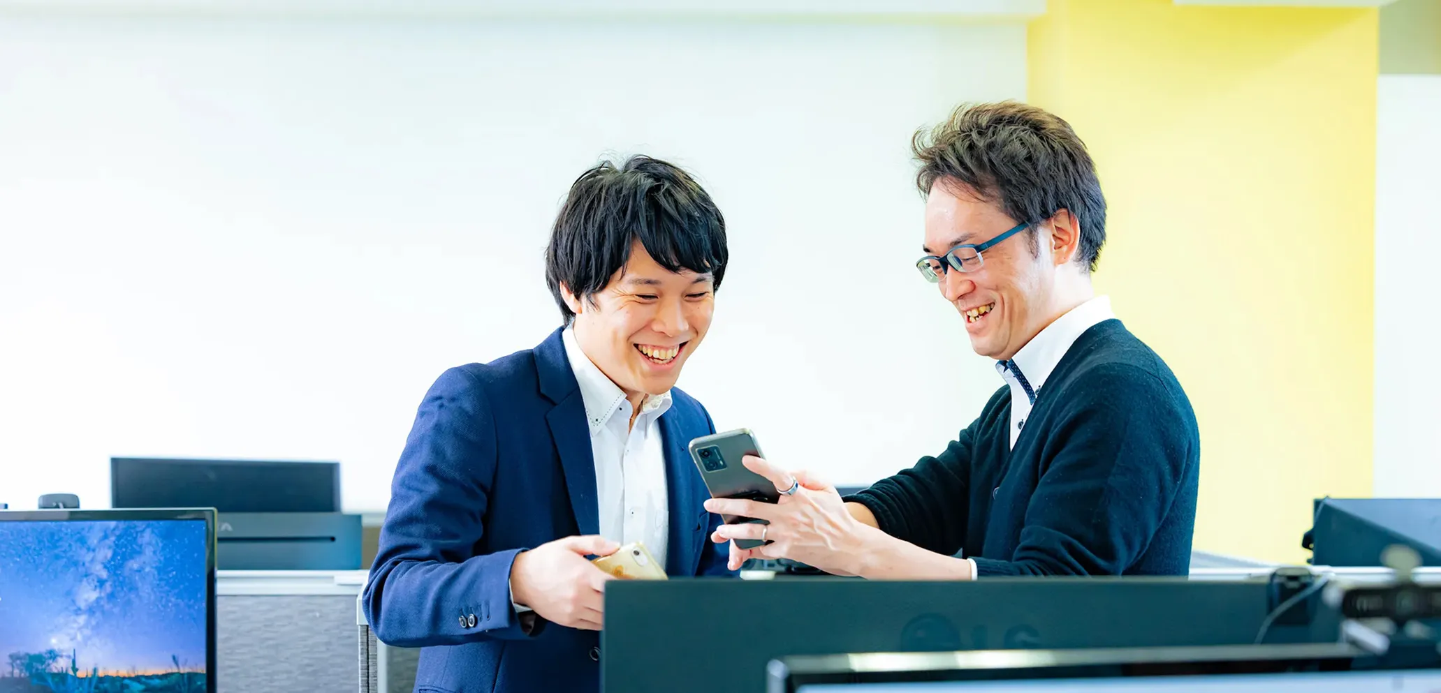 スマホを見て会話をしている男性2人